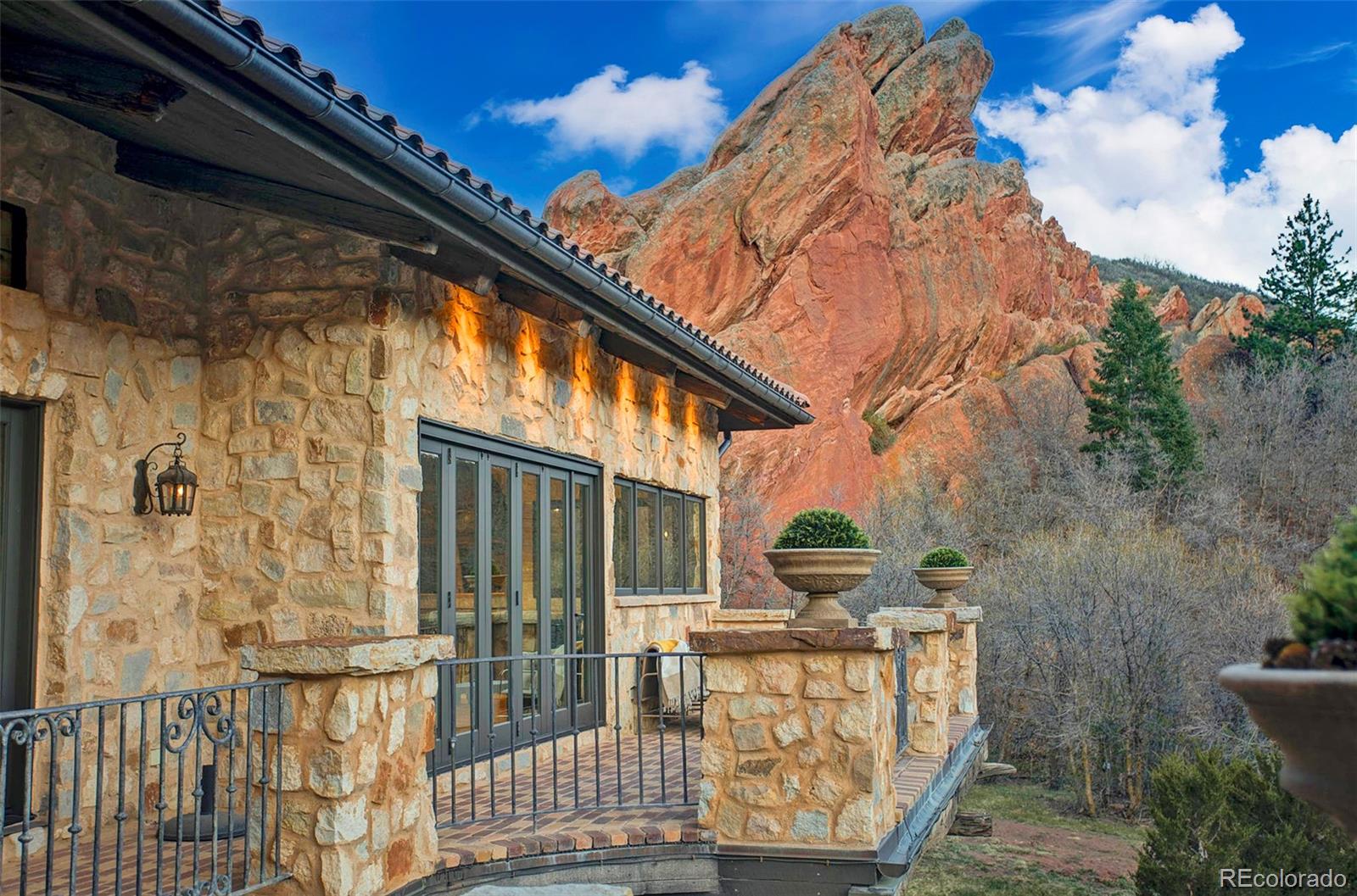 3755 North Rampart Range Road Littleton, CO 80125 - Photo 43 of 50 a front view of a house with outdoor seating