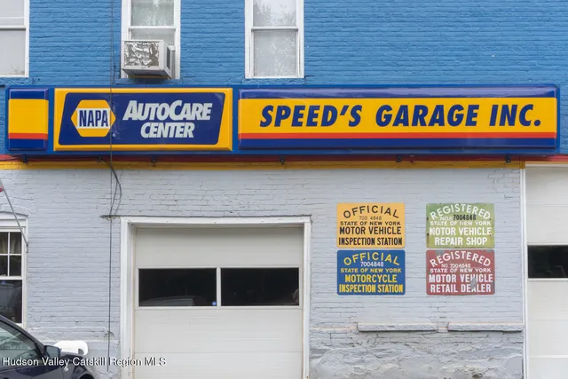 a sign that is on the side of a brick building