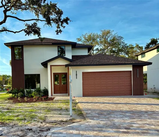 a front view of a house with a yard garage and a fireplace