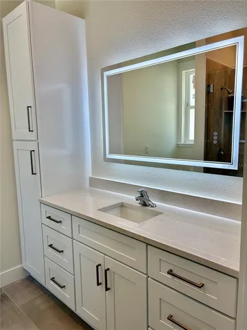 a room with wooden floor pool table and chairs