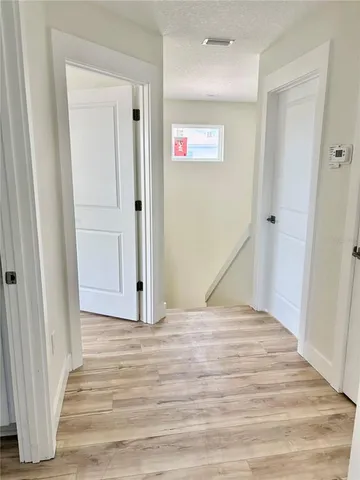 a view of room with window and wooden floor