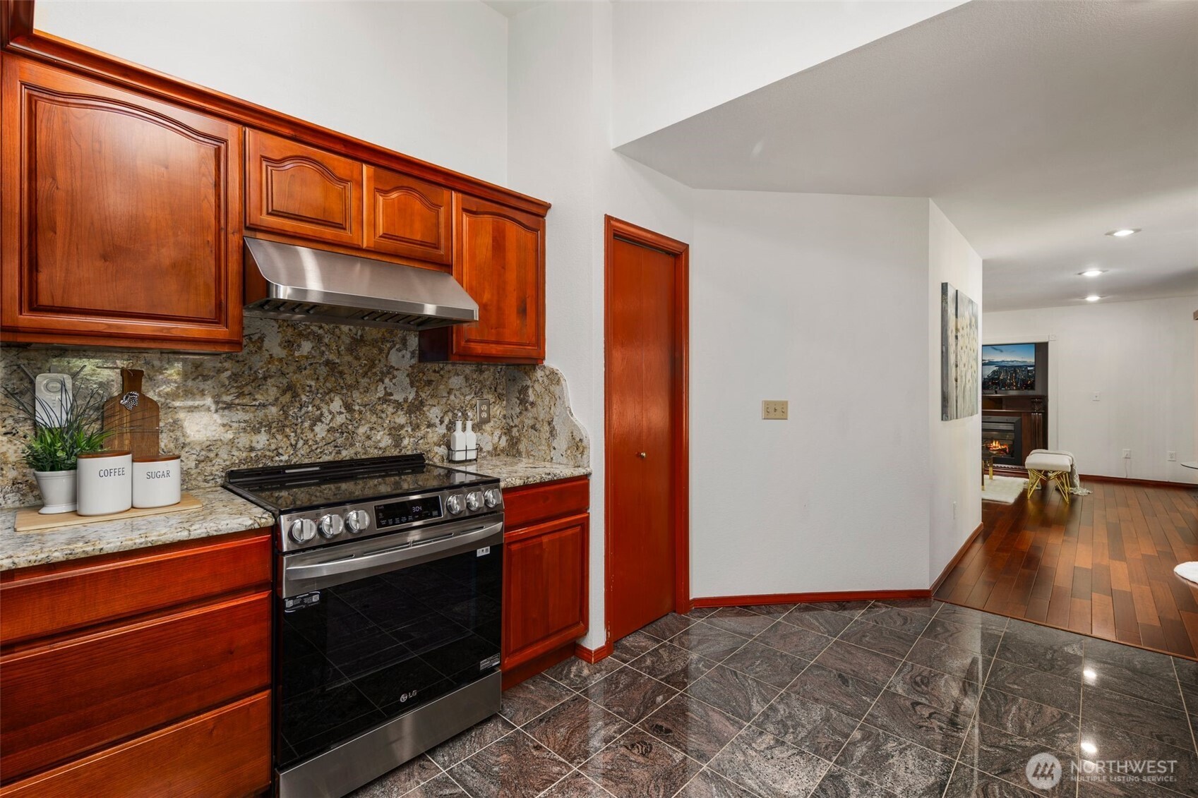 14015 Southeast 156th Court Renton, WA 98058 - Photo 12 of 36 a kitchen with stainless steel appliances granite countertop a stove a sink and a refrigerator