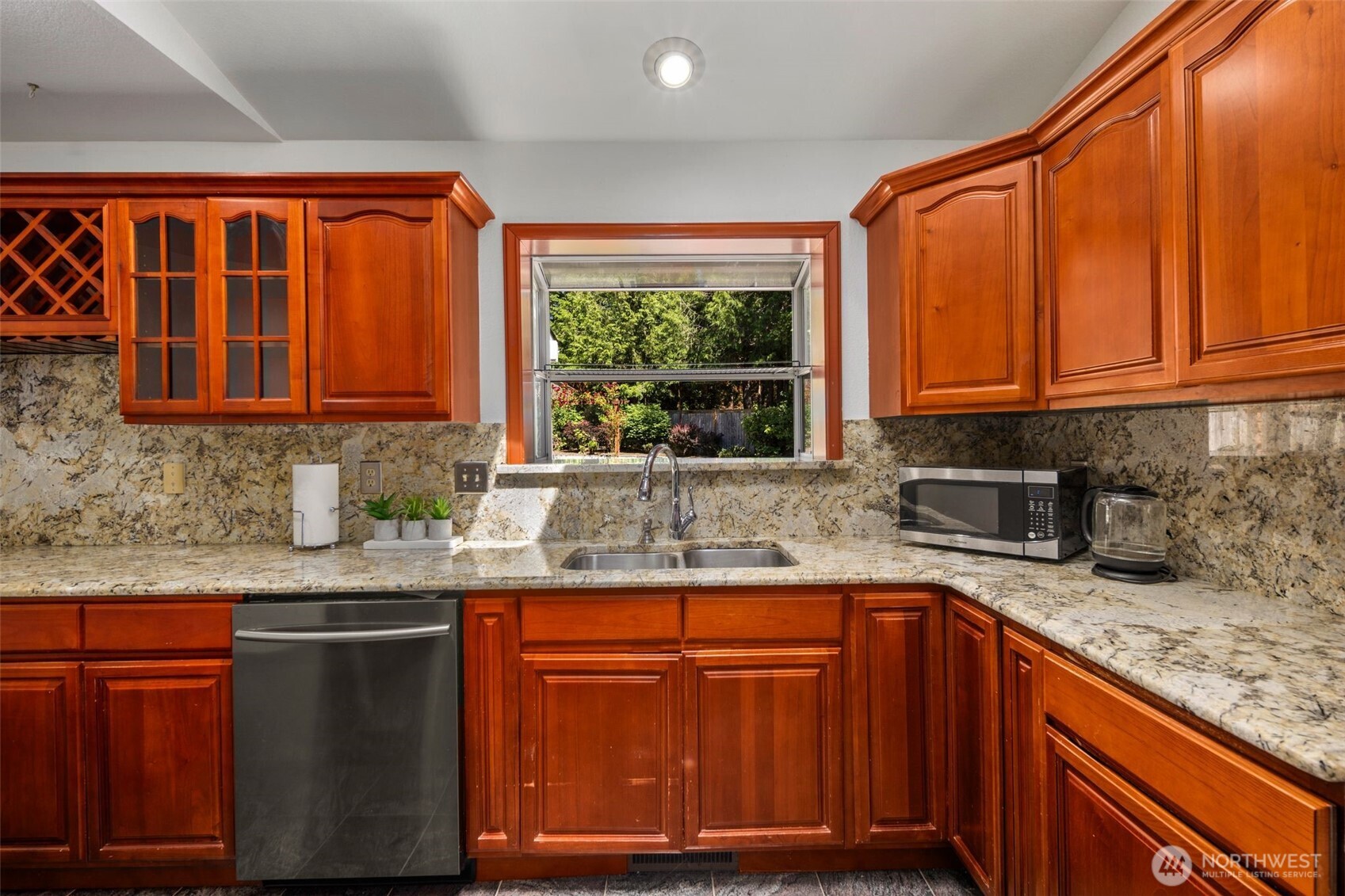 14015 Southeast 156th Court Renton, WA 98058 - Photo 13 of 36 a kitchen with granite countertop a sink window and cabinets