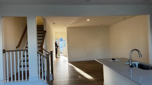 a view of a hallway with wooden floor and stairs