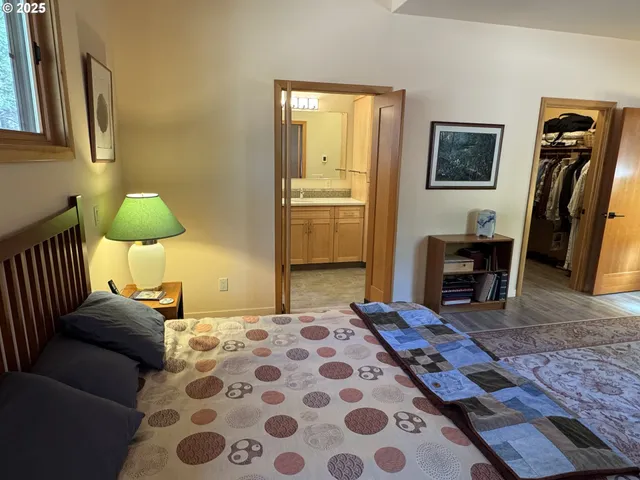 a bedroom with a bed and wooden floor