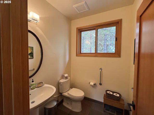 a bathroom with a toilet a sink and a mirror