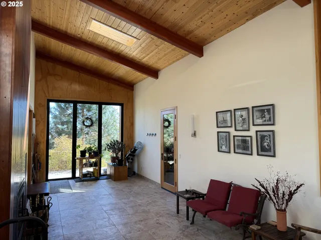 a view of a livingroom with furniture and a large window