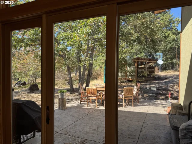 a view of a porch with chairs and backyard