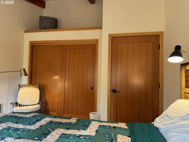 a bedroom with a bed and a chair