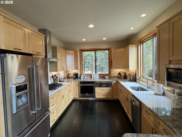 a kitchen with refrigerator a stove and a sink