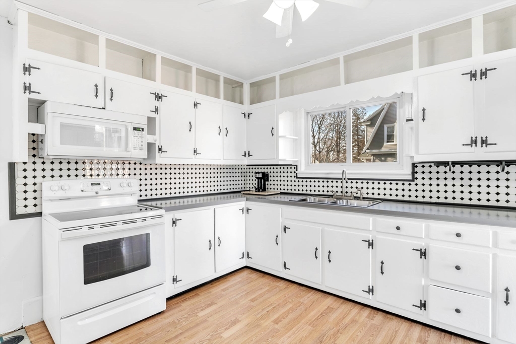 164 Phoenix Terrace Springfield, MA 01104 - Photo 11 of 39 a kitchen with white cabinets a sink and dishwasher