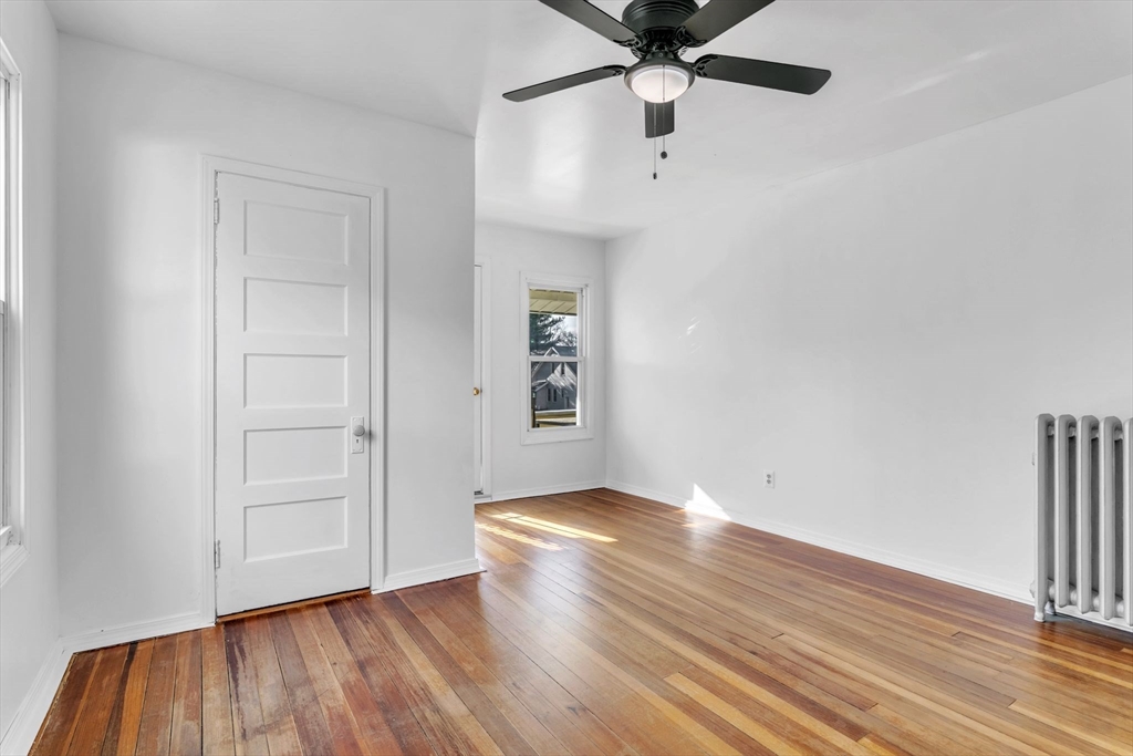 164 Phoenix Terrace Springfield, MA 01104 - Photo 19 of 39 wooden floor in an empty room with a window