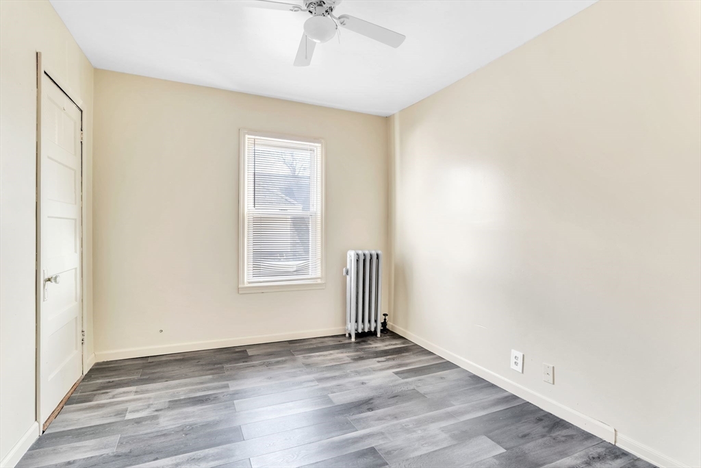 164 Phoenix Terrace Springfield, MA 01104 - Photo 28 of 39 an empty room with wooden floor and windows