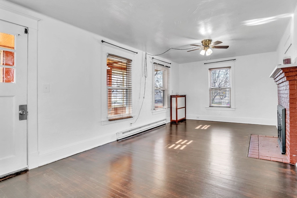 164 Phoenix Terrace Springfield, MA 01104 - Photo 6 of 39 a view of an empty room with wooden floor and a window
