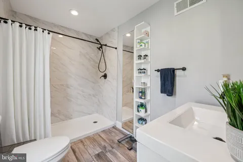a bathroom with a shower curtain a sink and a shower curtain