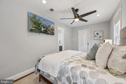 a bedroom with a bed and a painting on the wall
