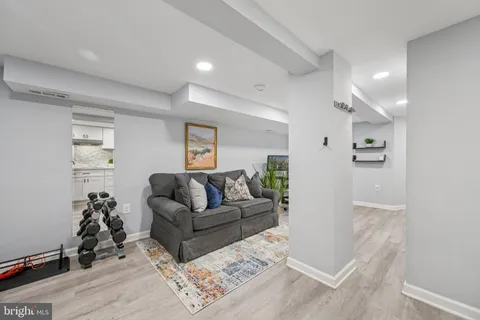 a living room with furniture and wooden floor