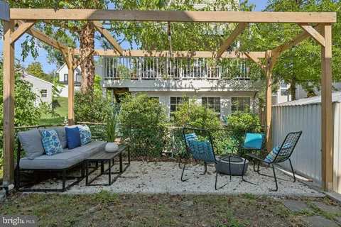 a view of a chair and table in backyard