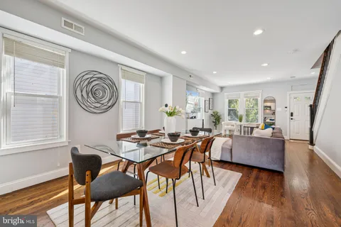 a view of a dining room with furniture window and wooden floor