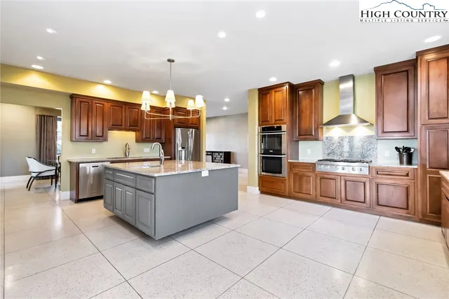 a large kitchen with a large counter top cabinets and appliances