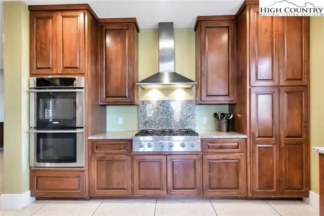 a kitchen with kitchen island granite countertop stainless steel appliances and cabinets