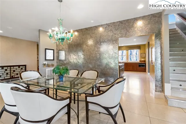 a dining room with furniture and chandelier