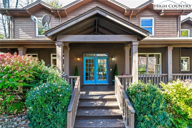 a view of a house with potted plants