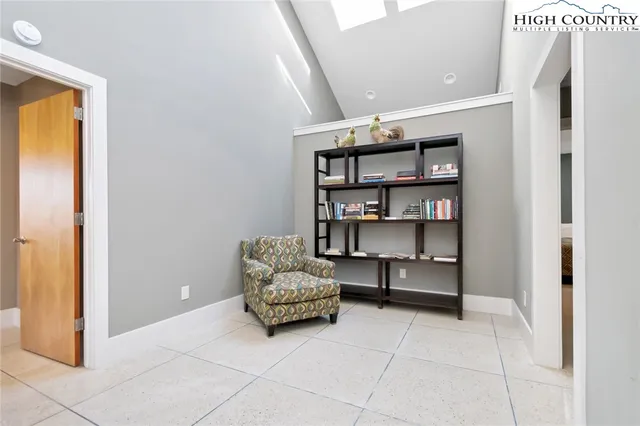 a living room with furniture and a book shelf