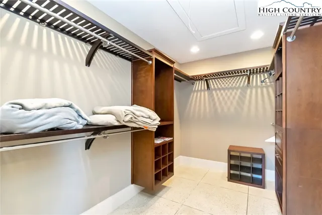 a bathroom with a granite countertop double vanity sink and a mirror