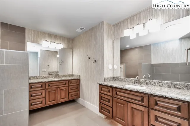 a bathroom with a tub a sink and a shower