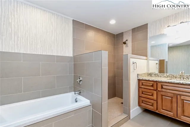 a bathroom with a bathtub and shower