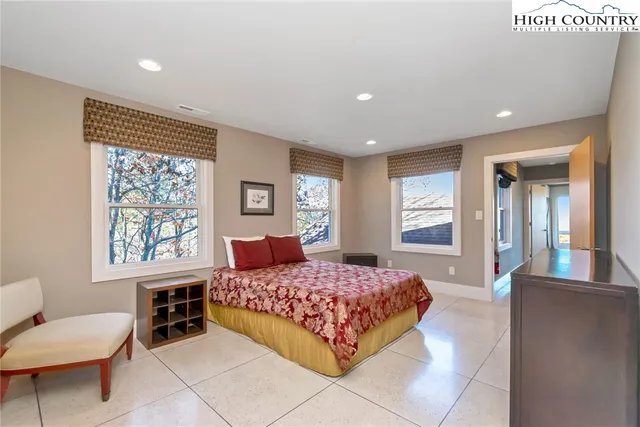 a bedroom with a large bed and a window