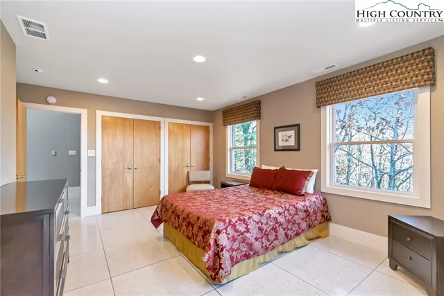 a bedroom with two beds and a large window