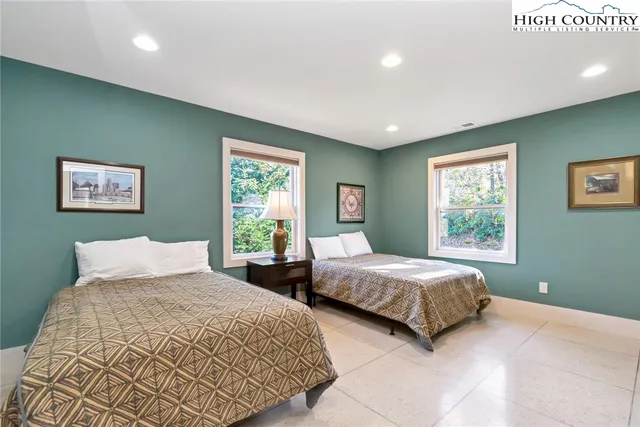 a bedroom with a bed and a lamp