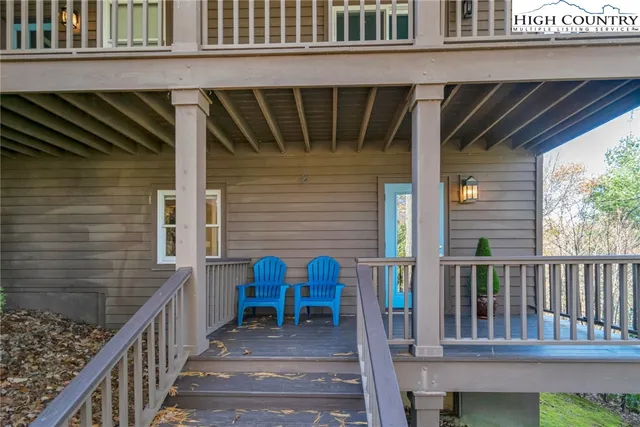 a spacious bedroom with a bed a table and chair