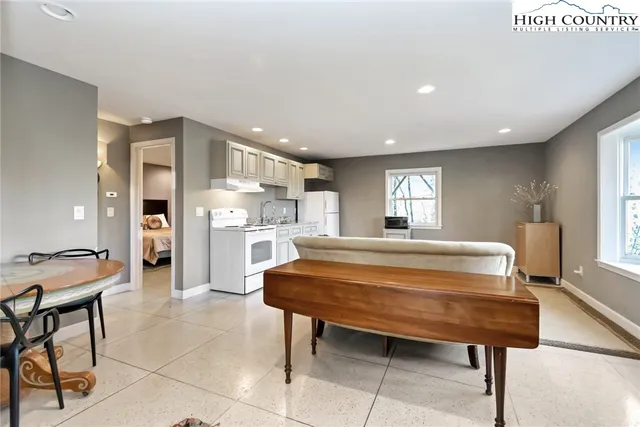a large bedroom with a table and chairs