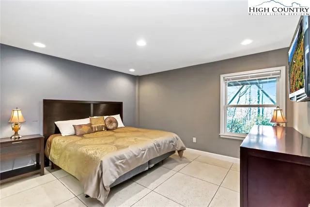 a bedroom with a bed and a lamp