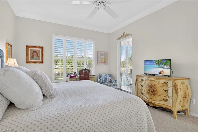 a bedroom with a bed a large window and chair