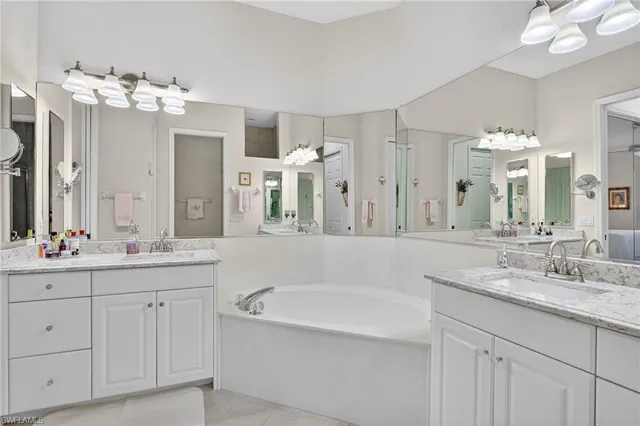 a spacious bathroom with a granite countertop sink and a mirror