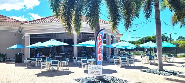 a small pool is sitting in front of a brick building