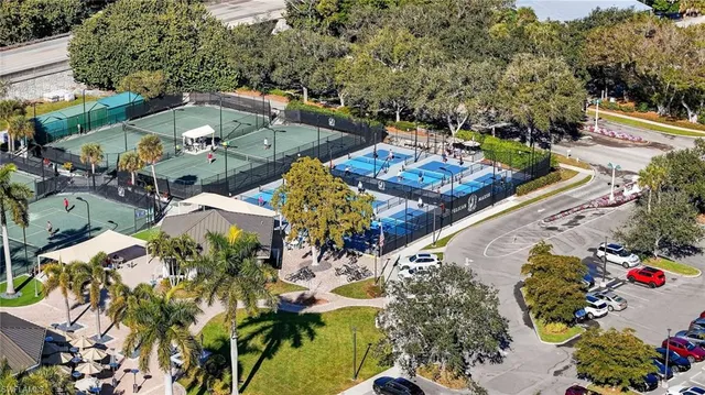 a kitchen with stainless steel appliances kitchen island granite countertop a dining table and chairs