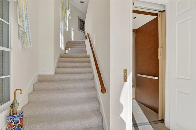 a view of staircase with lots of frames on wall