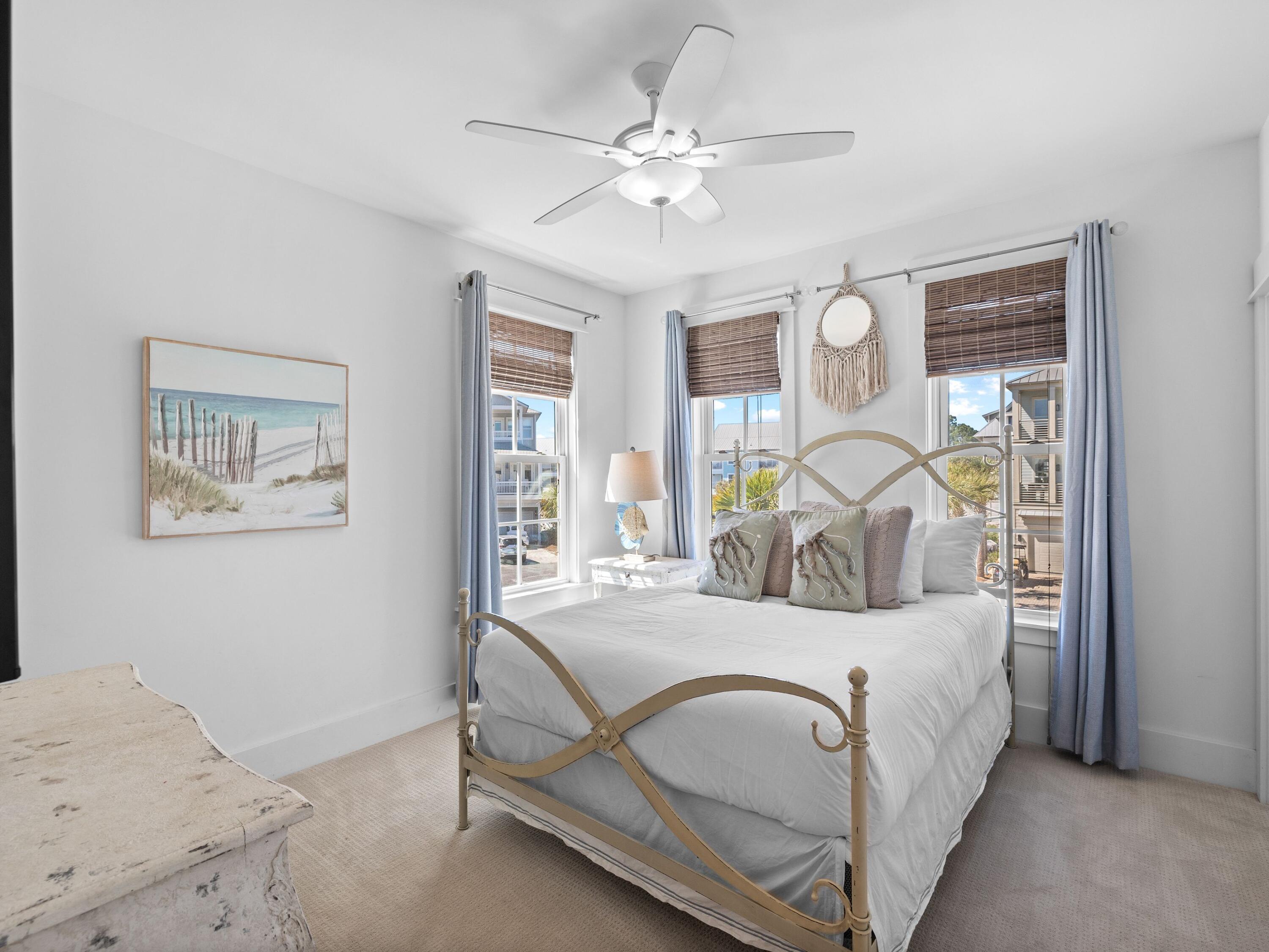 113 Dunes Estates Boulevard Santa Rosa Beach, FL 32459 - Photo 28 of 35 a bedroom with a bed mirror and a large window