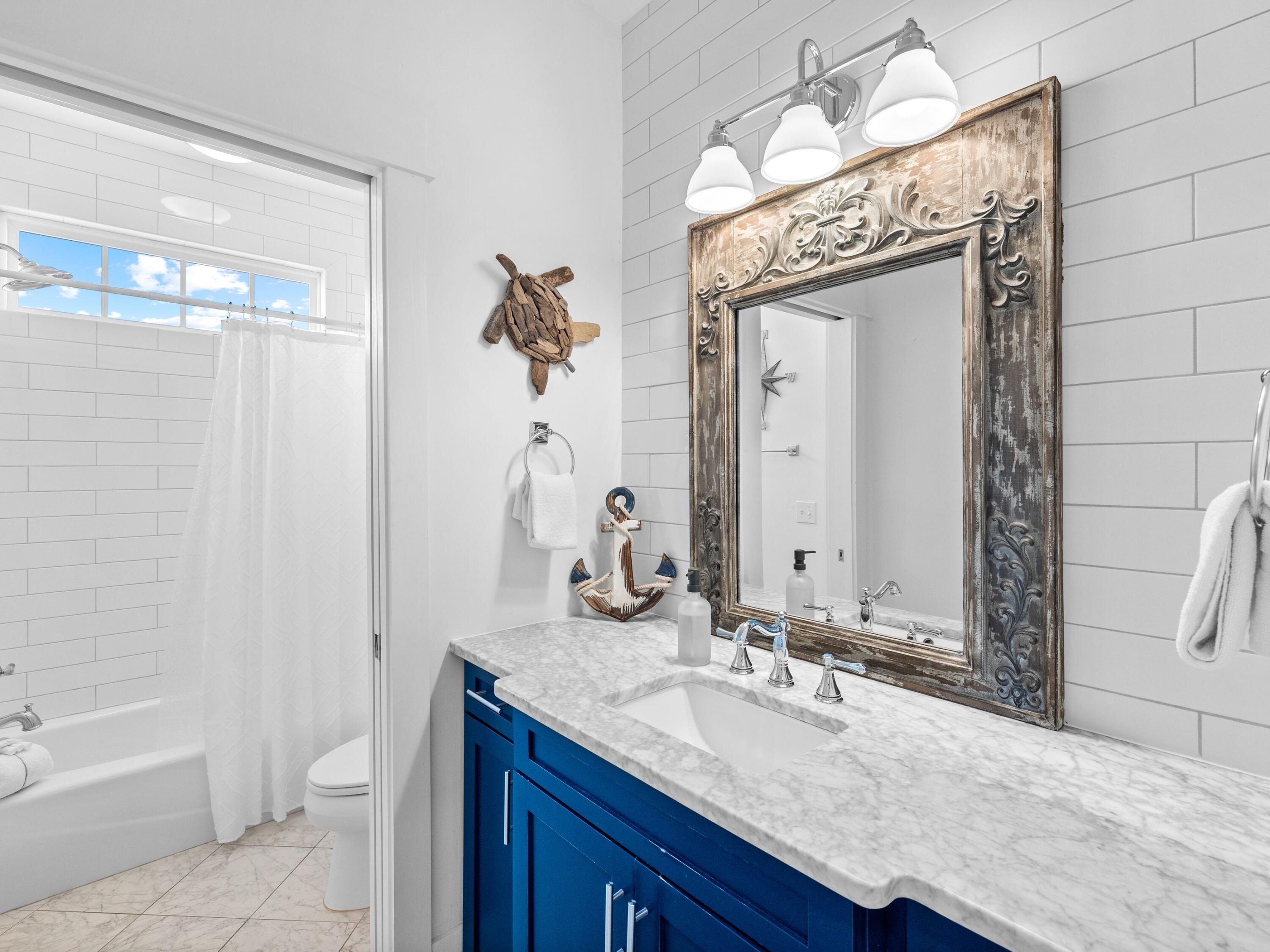 113 Dunes Estates Boulevard Santa Rosa Beach, FL 32459 - Photo 29 of 35 a bathroom with a granite countertop sink a toilet and a mirror