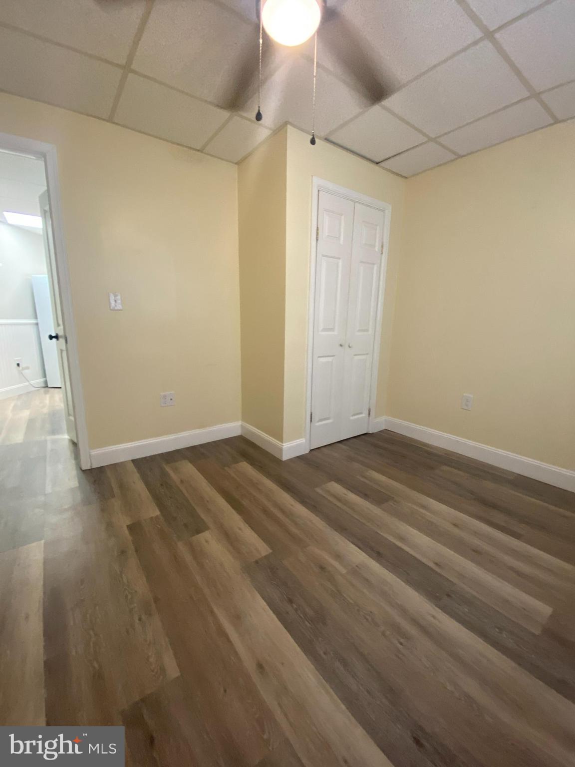 53 Gilmore Street, Unit A Keyser, WV 26726 - Photo 6 of 9 an empty room with wooden floor and windows