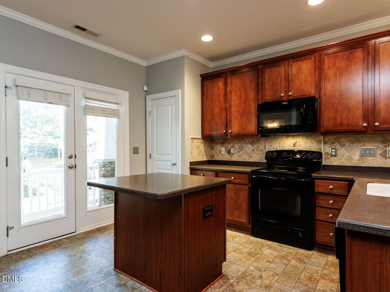 8729 Cypress Grove Run Raleigh, NC 27612 - Photo 12 of 41 a kitchen with stainless steel appliances granite countertop a stove a sink and a microwave