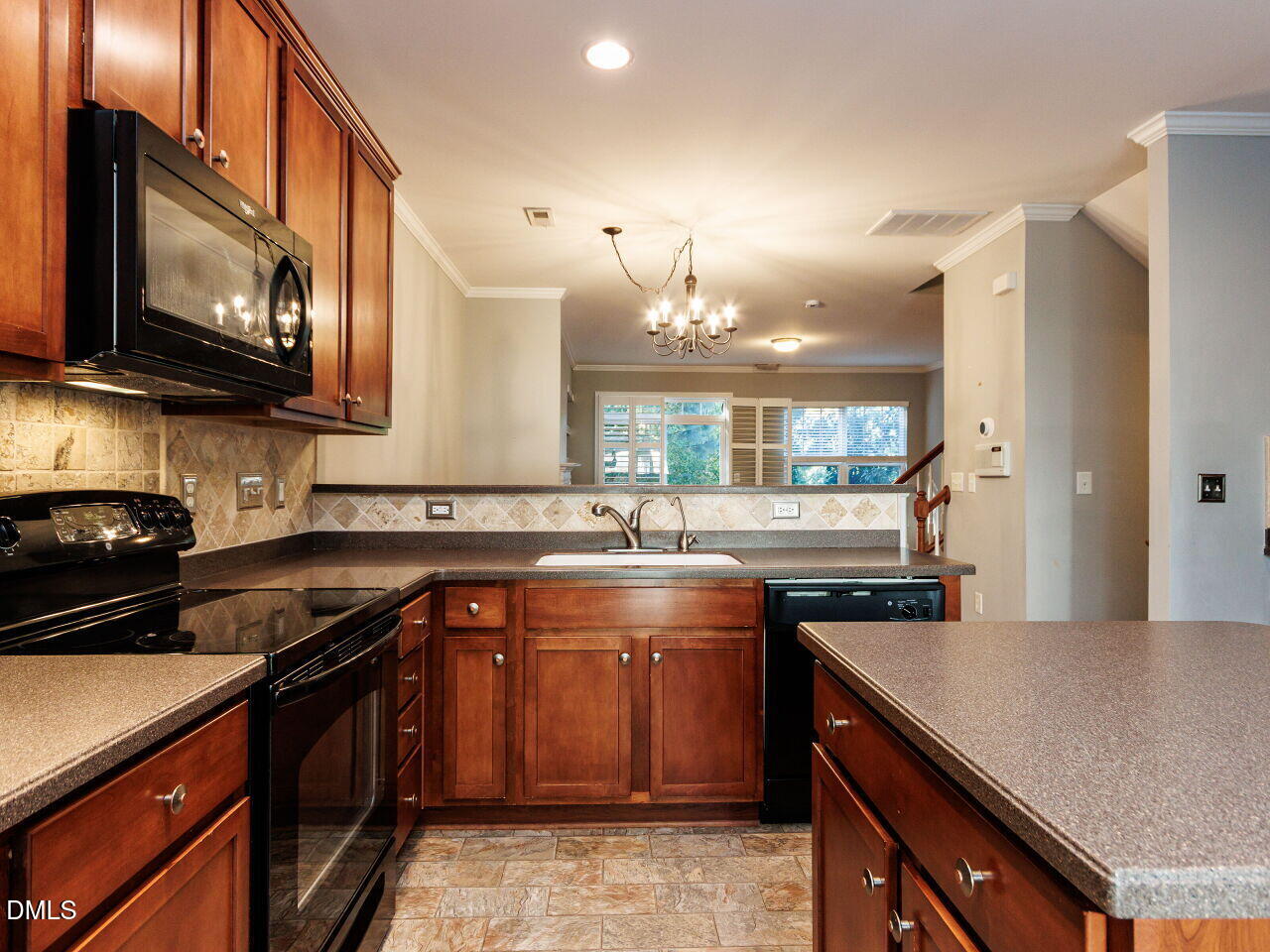 8729 Cypress Grove Run Raleigh, NC 27612 - Photo 14 of 41 a kitchen with stainless steel appliances granite countertop a stove a sink dishwasher and a microwave oven with large cabinets