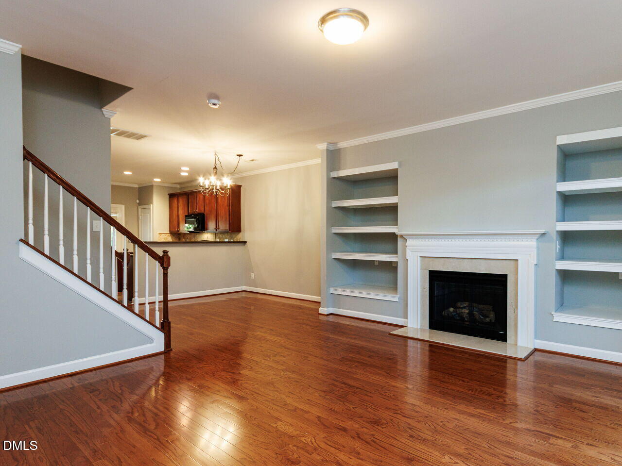 8729 Cypress Grove Run Raleigh, NC 27612 - Photo 6 of 41 a view of an empty room with wooden floor fireplace and a window
