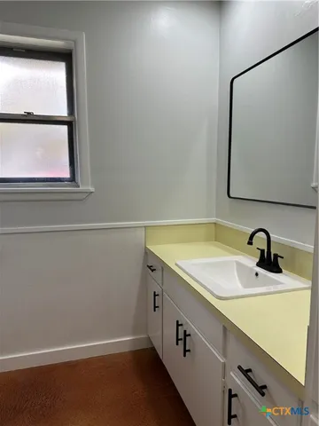 a white bath tub sitting next to a toilet