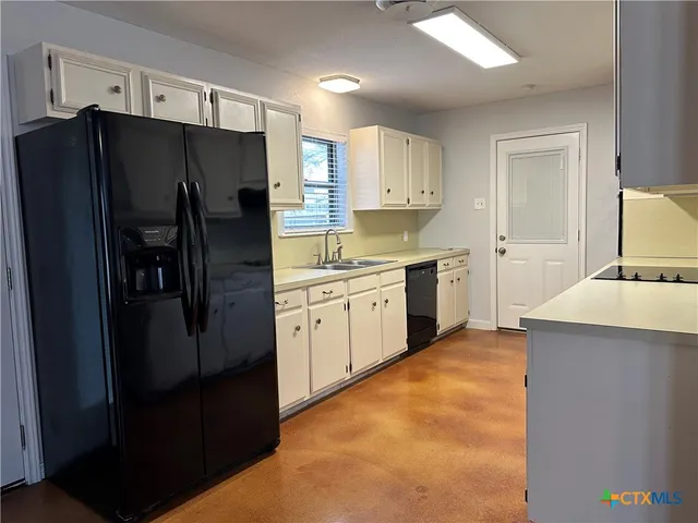 a kitchen with stainless steel appliances granite countertop a stove and a refrigerator